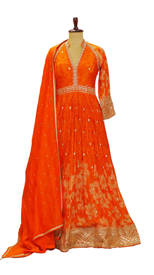 Orange embroidered Anarkali dress with matching dupatta on a mannequin against a plain background