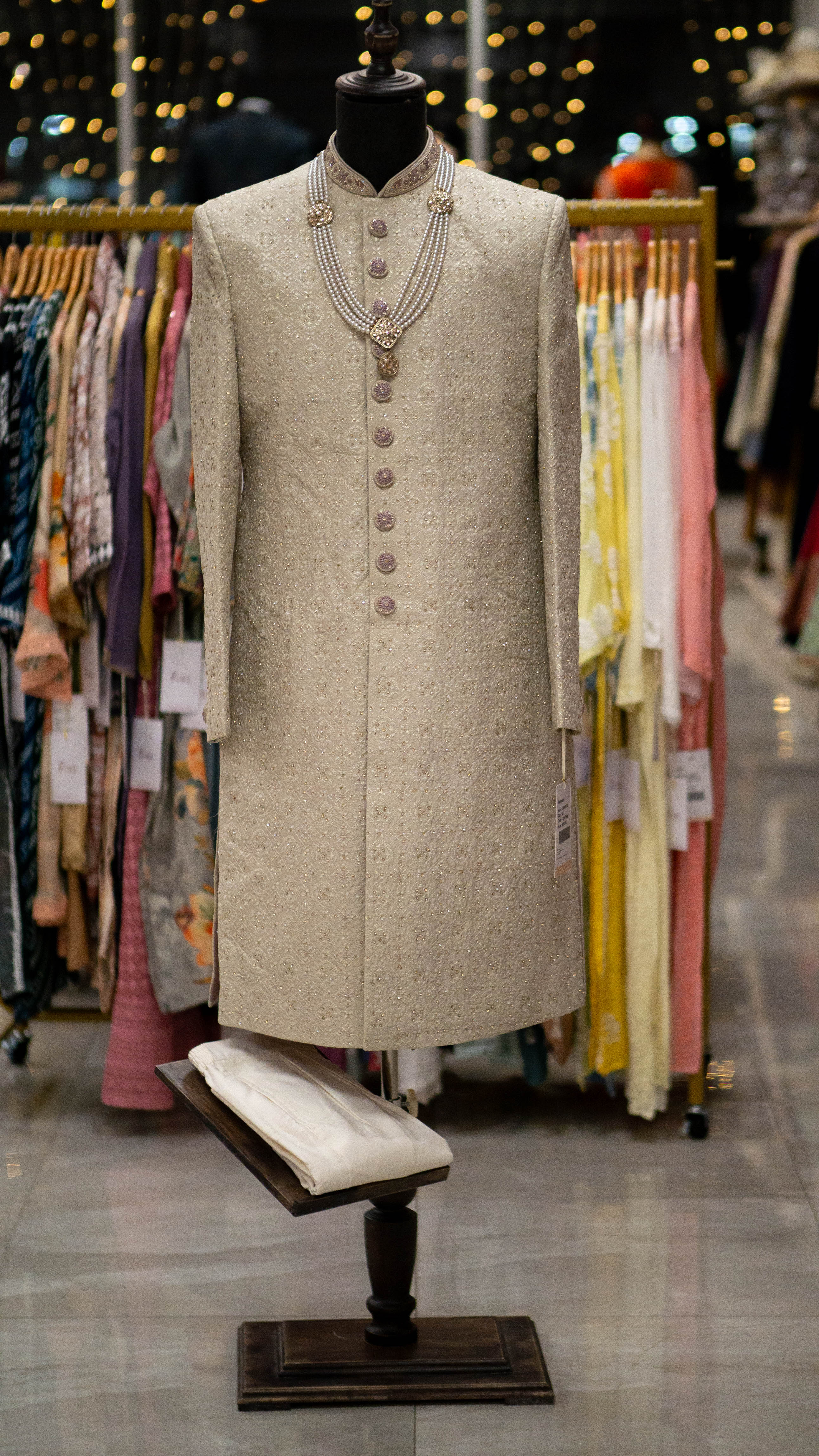 Traditional sherwani on a mannequin in a clothing store setting