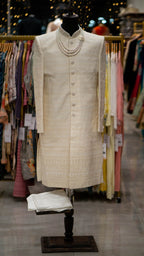 Traditional Ivory colored Sherwani on a mannequin in a clothing store setting