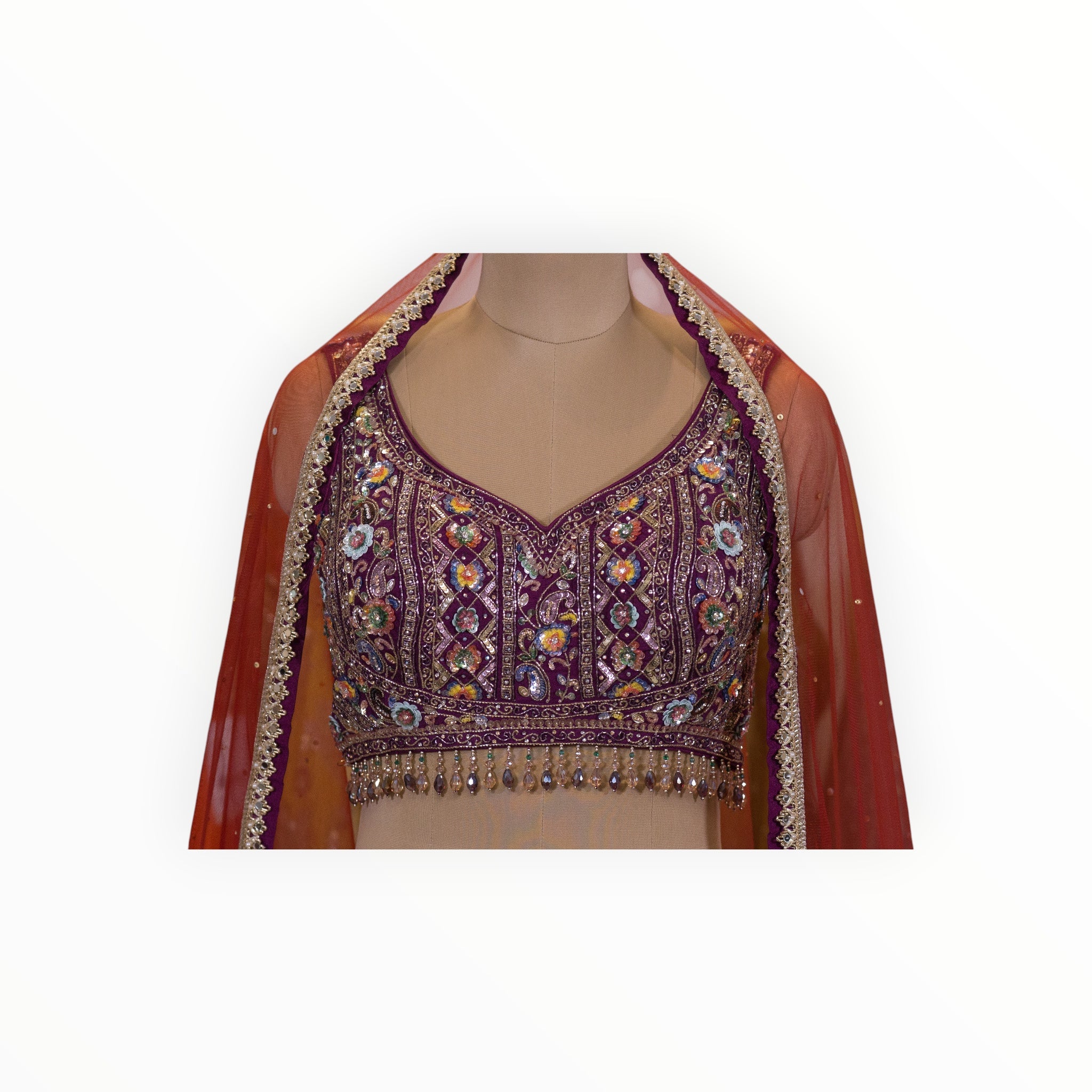Zari Designs Banarsi Lehnga featuring a deep purple embroidered blouse with intricate beadwork and a red dupatta.