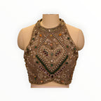 Zari Designs beige halter neck blouse featuring intricate multi-colored gemstone and pearl embroidery on a mannequin.