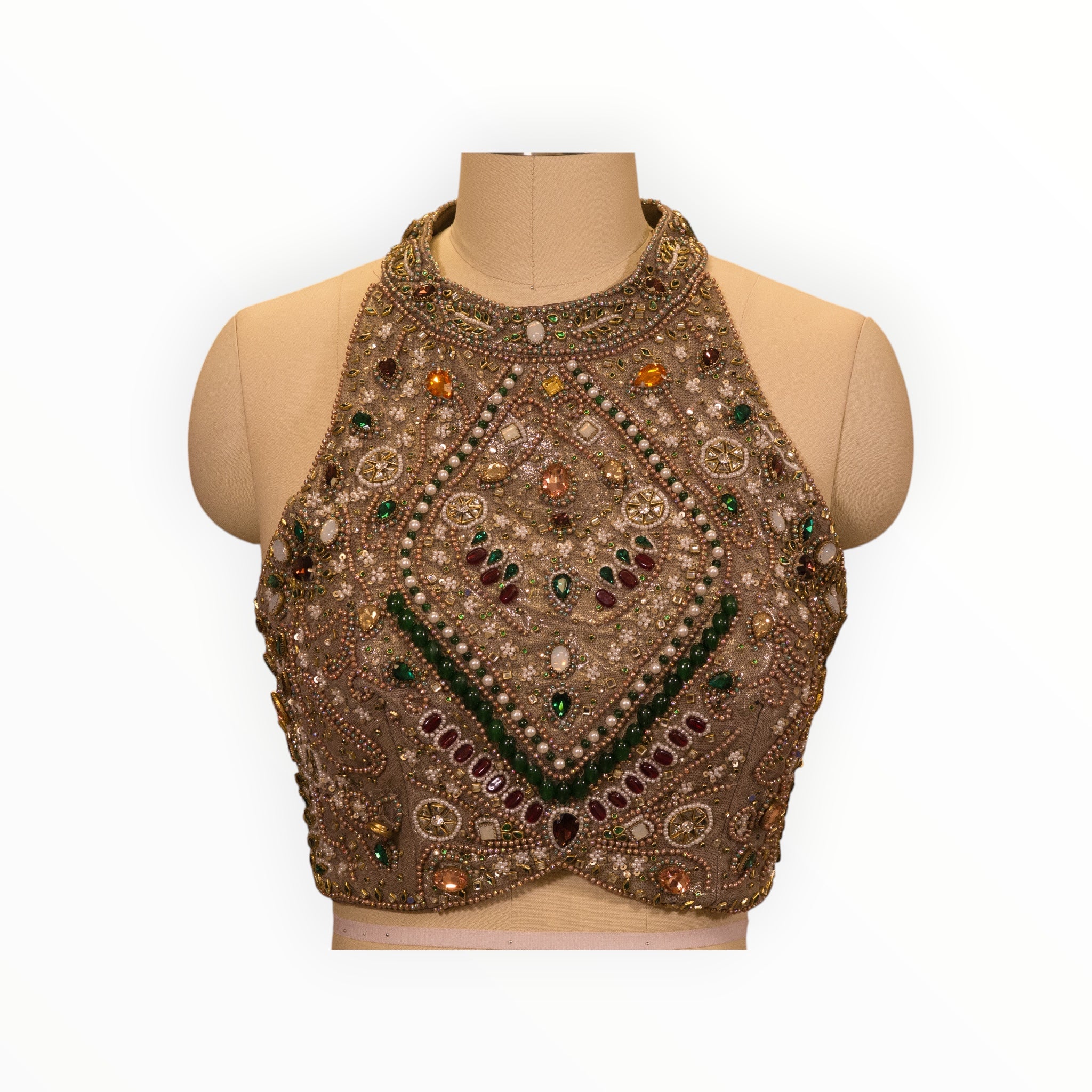 Zari Designs beige halter neck blouse featuring intricate multi-colored gemstone and pearl embroidery on a mannequin.