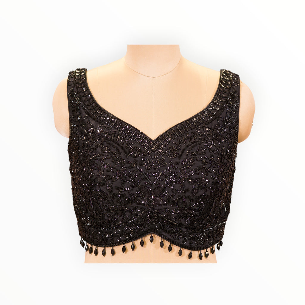 Zari Designs black sleeveless blouse featuring intricate beadwork and floral embroidery on a mannequin