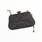 Zari Designs black clutch bag with intricate green beadwork and floral embroidery, featuring a crystal clasp.