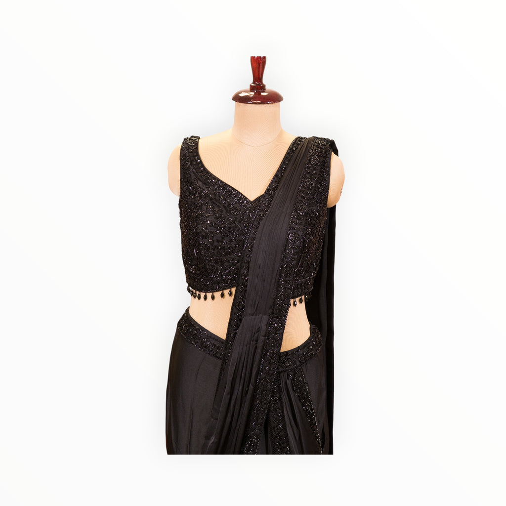 Zari Designs black ready-to-wear saree featuring a sleeveless blouse with intricate beadwork and sequin embroidery.