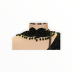 Zari Designs black drape saree featuring an intricate embroidered choker neckline with hanging emerald green beads.