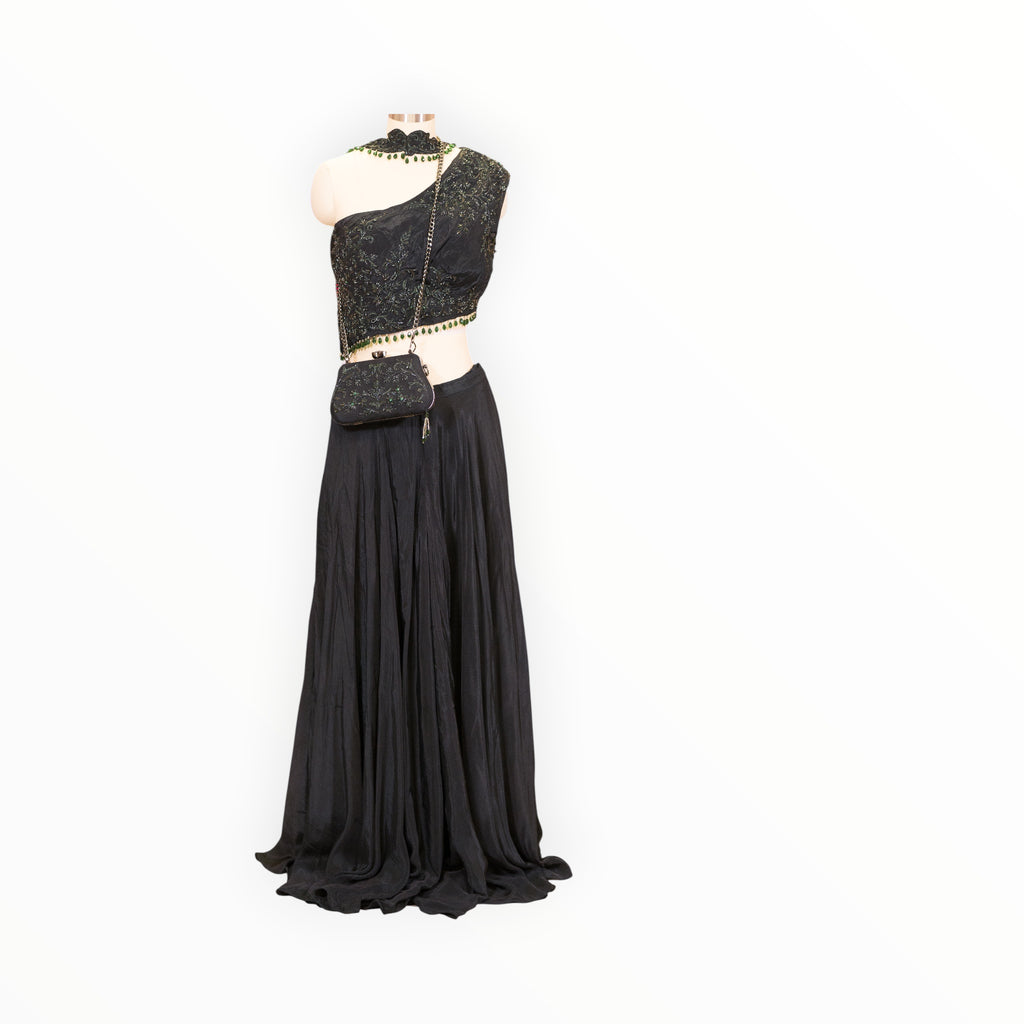 Zari Designs black drape saree with an embellished one-shoulder blouse and matching beaded clutch on a mannequin
