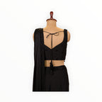 Zari Designs black ready-to-wear saree with a sleeveless blouse featuring beaded embroidery and a back tie detail.