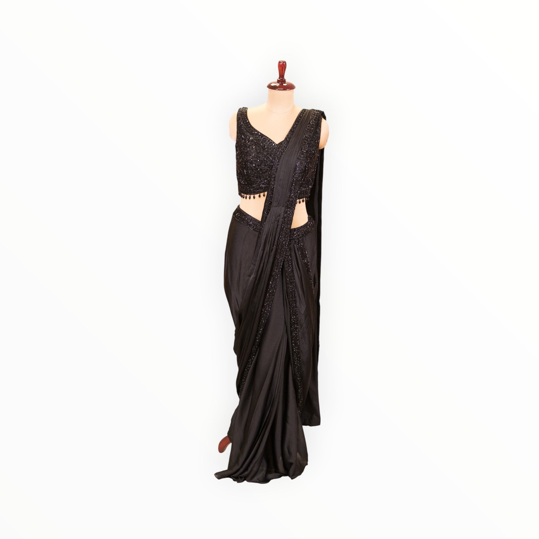 Zari Designs black ready-to-wear saree featuring a sleeveless sequined blouse with beaded hem detail on a mannequin.
