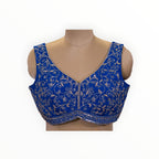 Zari Designs royal blue sleeveless saree blouse featuring intricate silver thread embroidery and sequin detailing.
