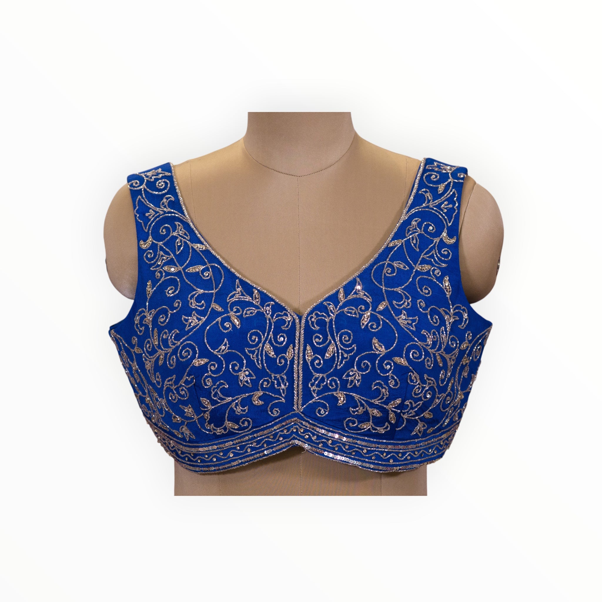 Zari Designs royal blue sleeveless saree blouse featuring intricate silver thread embroidery and sequin detailing.