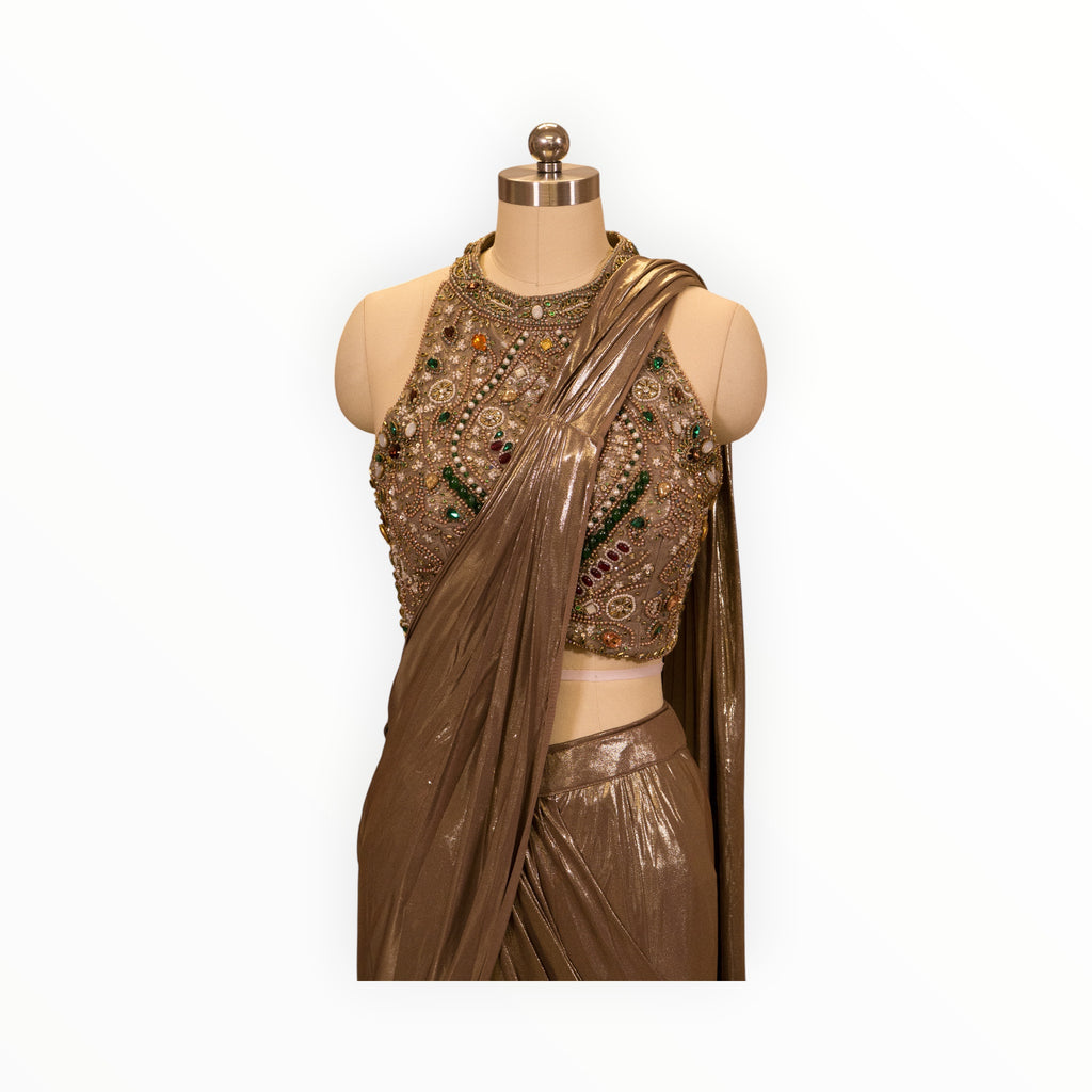 Zari Designs metallic bronze drape saree featuring a high-neck blouse with intricate bead, stone, and pearl embroidery.