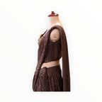 Zari Designs dark brown ready-to-wear saree featuring intricate sequin embroidery and a sleeveless blouse on a mannequin