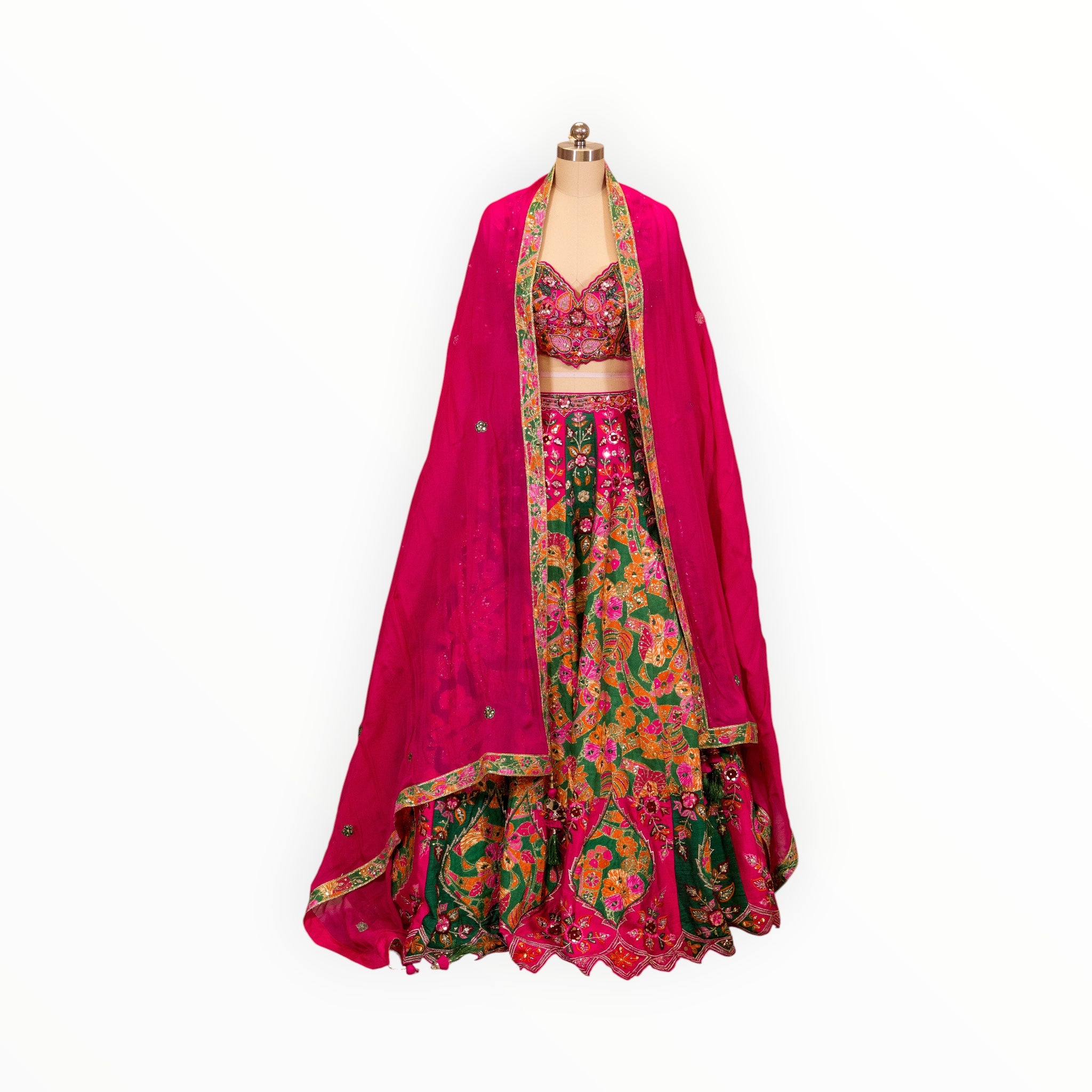 Zari Designs Carnival Lehnga featuring a vibrant green and pink floral embroidered skirt with a matching crop top