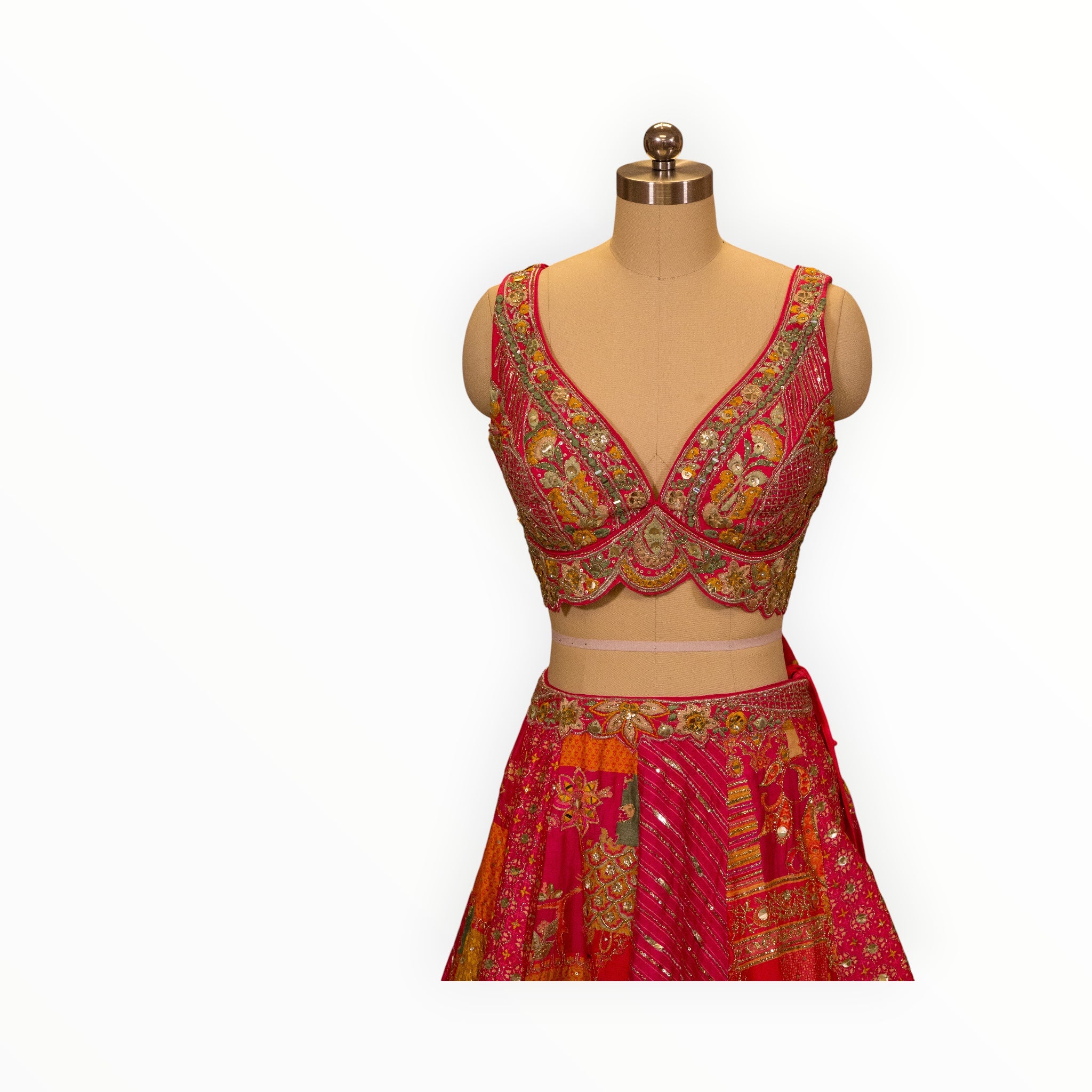 Zari Designs Carnival Lehnga featuring vibrant pink patchwork fabric with intricate gold embroidery and mirror work.