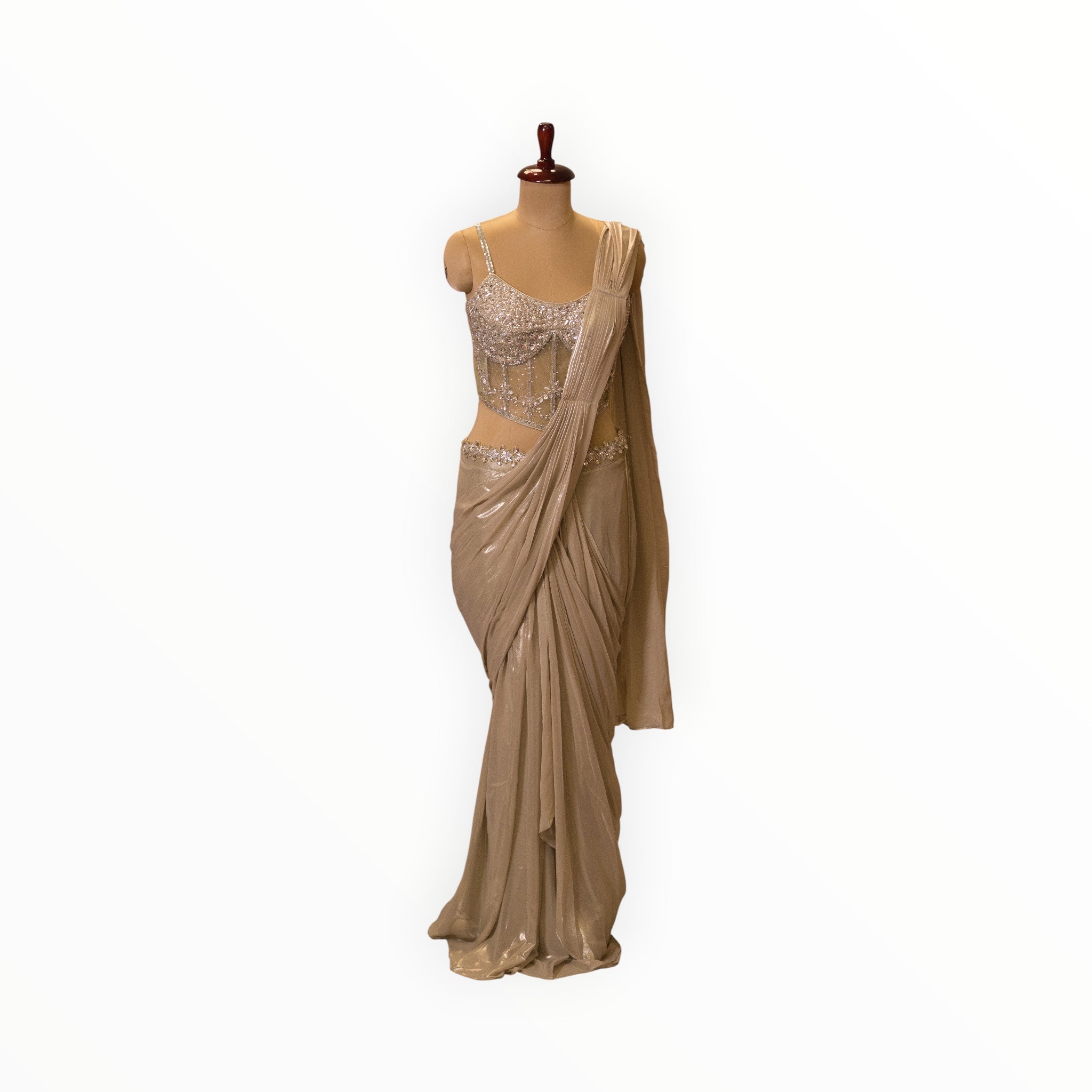Zari Designs champagne gold ready-to-wear saree with a heavily embellished sequin corset blouse on a mannequin.