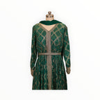 Zari Designs emerald green Anarkali dress with gold bandhani print, V-neck, and intricate embroidered waist belt.