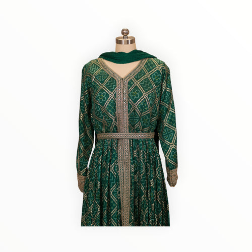 Zari Designs emerald green Anarkali dress with gold bandhani print, V-neck, and intricate embroidered waist belt.