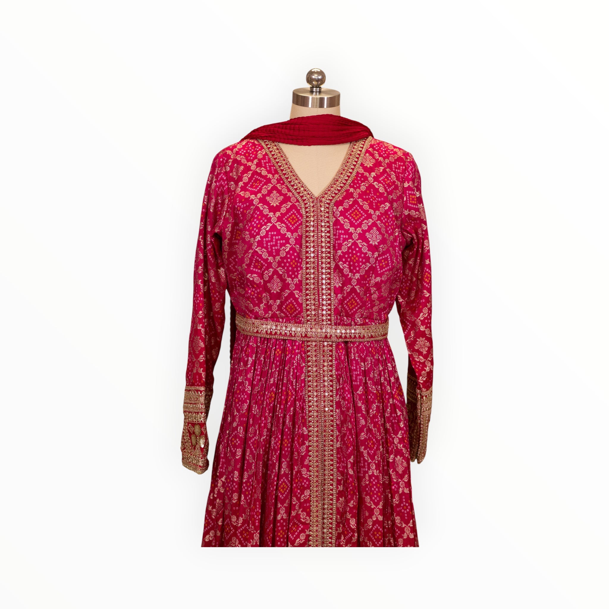 Zari Designs fuchsia pink Anarkali dress with intricate gold embroidery, mirror work, and a matching red dupatta.