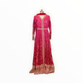 Zari Designs fuchsia pink Anarkali dress with intricate gold embroidery, bandhani print, and a matching dupatta.