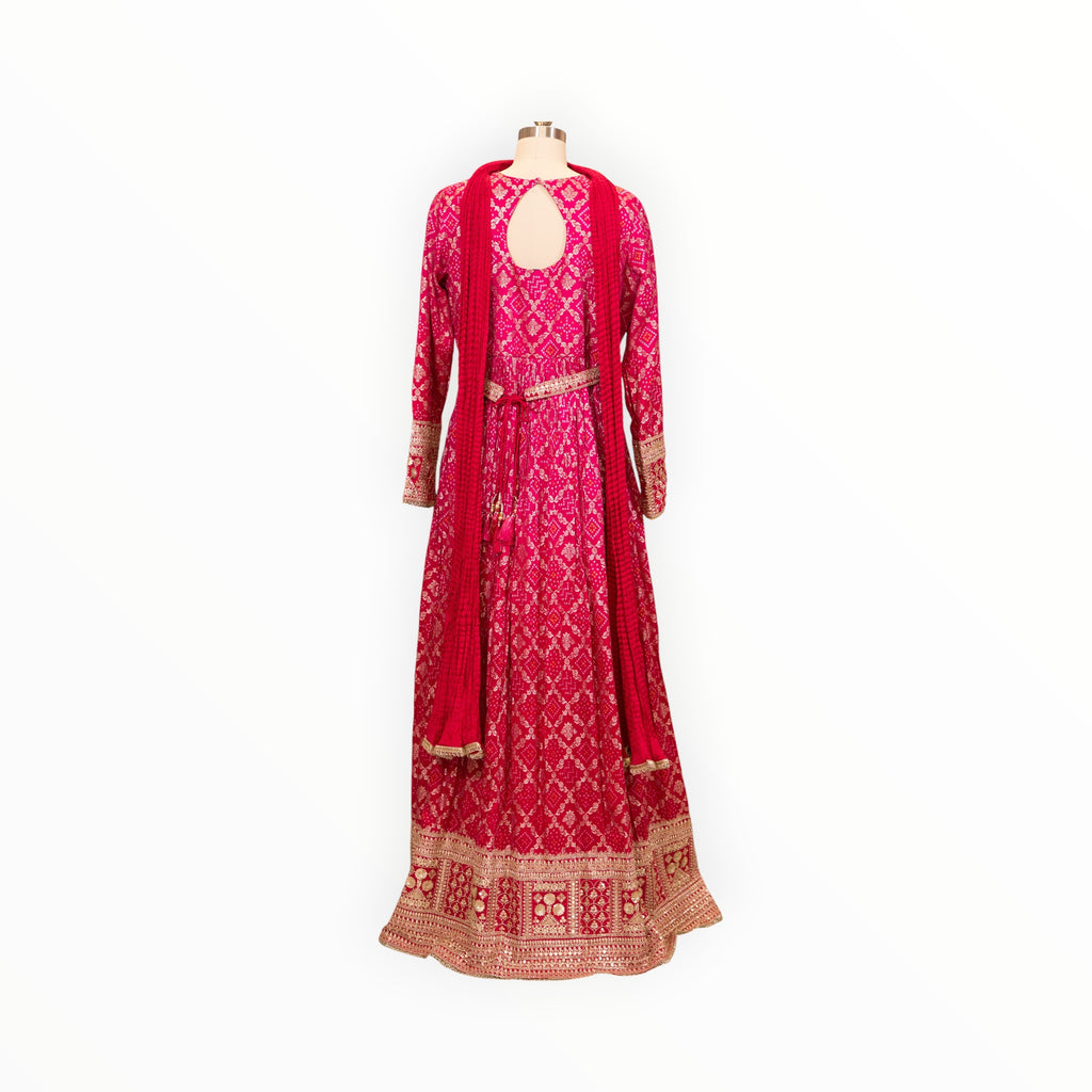 Zari Designs fuchsia pink Anarkali dress with intricate bandhani print, keyhole back, and heavy gold embroidered hem.