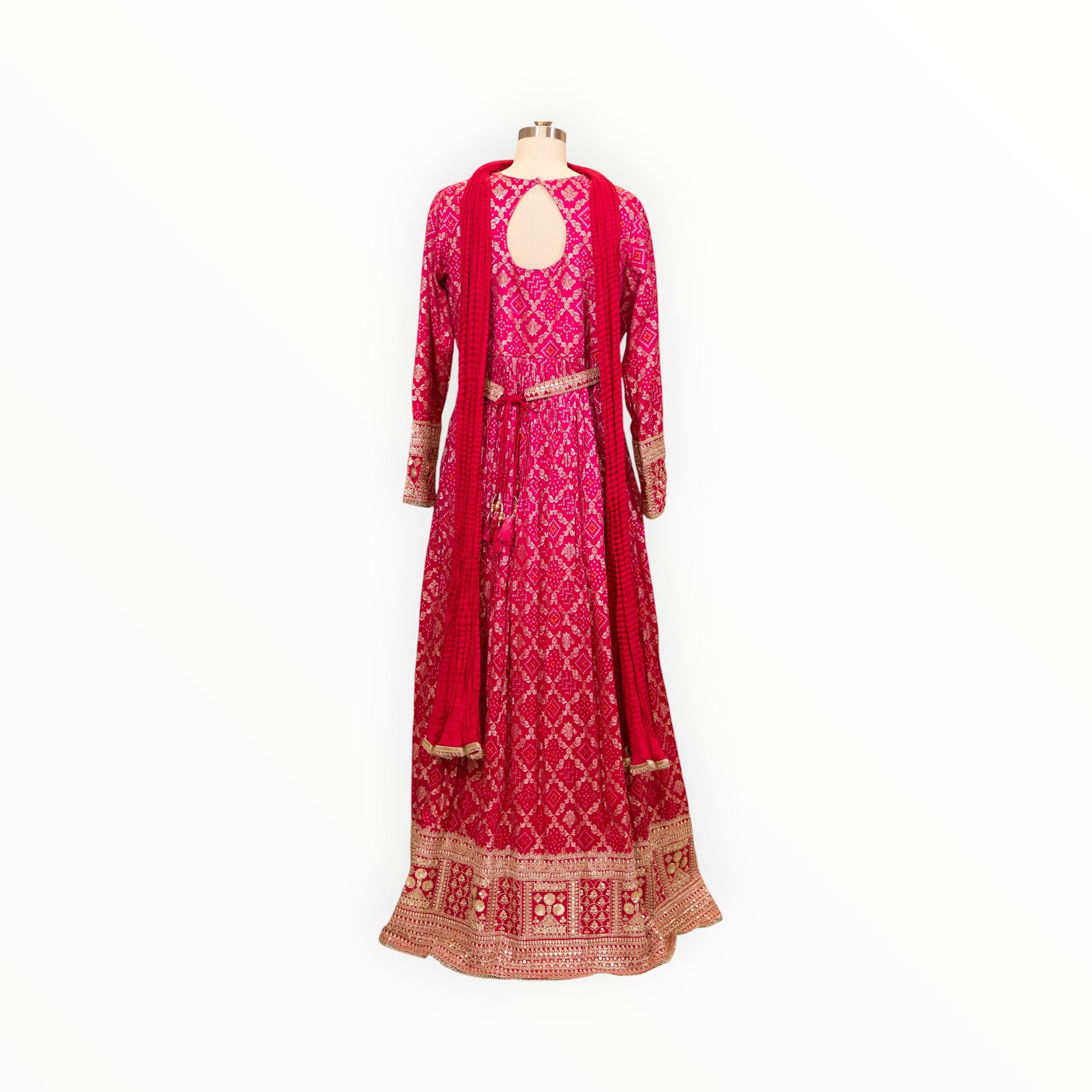 Zari Designs fuchsia pink Anarkali dress with intricate bandhani print, keyhole back, and heavy gold embroidered hem.