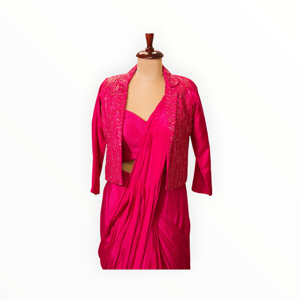 Zari Designs fuchsia pink Indo-Western saree gown featuring a draped skirt and a sequin-embellished cropped blazer.
