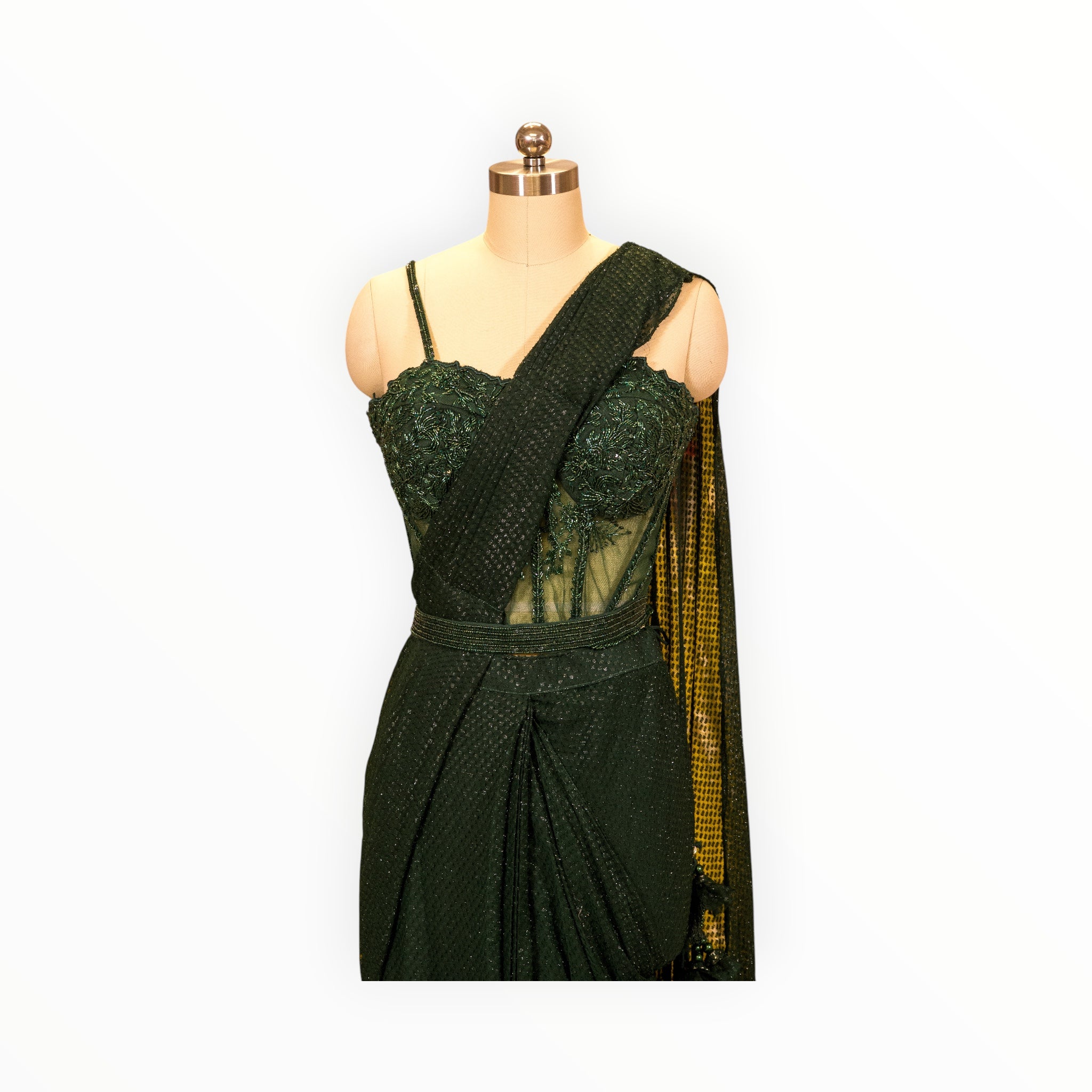 Zari Designs deep green pre-draped saree with an embellished corset blouse and matching waist belt on a mannequin.