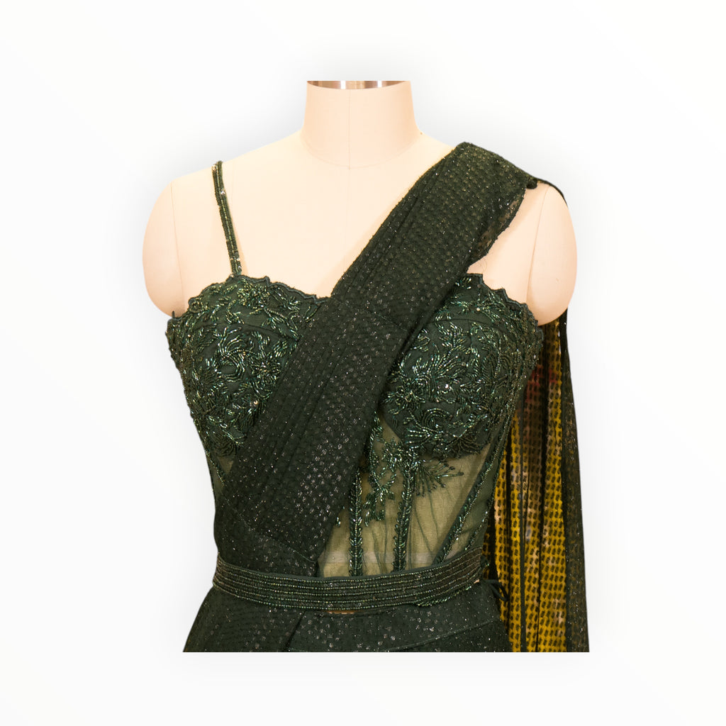 Zari Designs deep green pre-draped saree with an embellished corset blouse and matching waist belt on a mannequin.