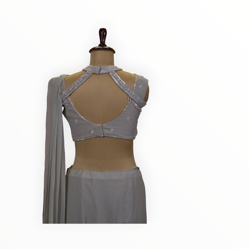 Zari Designs grey georgette ready drape saree featuring a sleeveless blouse with intricate silver sequin embroidery