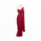 Zari Designs deep magenta draped saree with a matching embellished sleeveless blouse on a mannequin