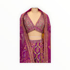 Zari Designs Carnival Lehnga in vibrant magenta with intricate mirror work, embroidery, and a matching sheer dupatta.