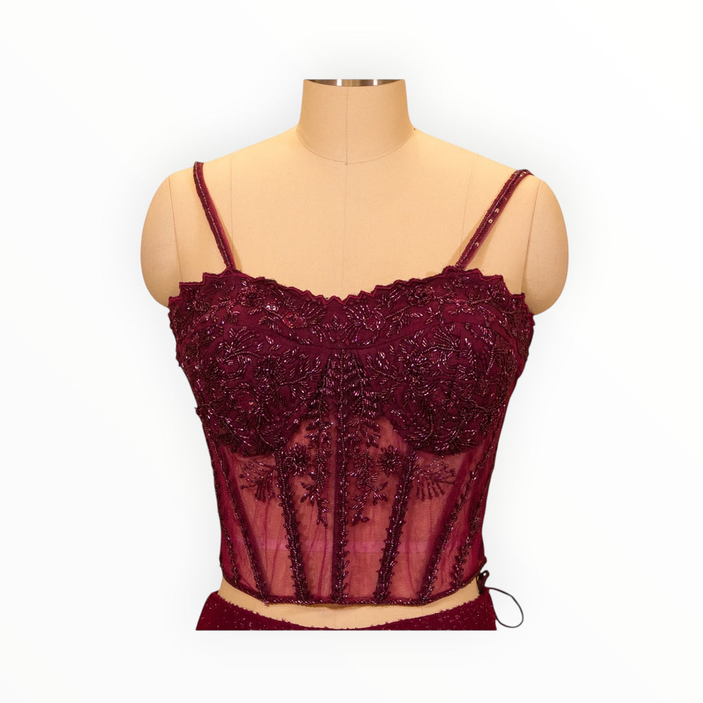 Zari Designs maroon corset blouse with intricate beadwork and embroidery on a mannequin in a clothing store
