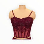 Zari Designs maroon corset blouse with intricate beadwork and embroidery on a mannequin in a clothing store