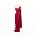 Zari Designs maroon pre-draped saree with an embellished corset blouse and matching waist belt on a mannequin.
