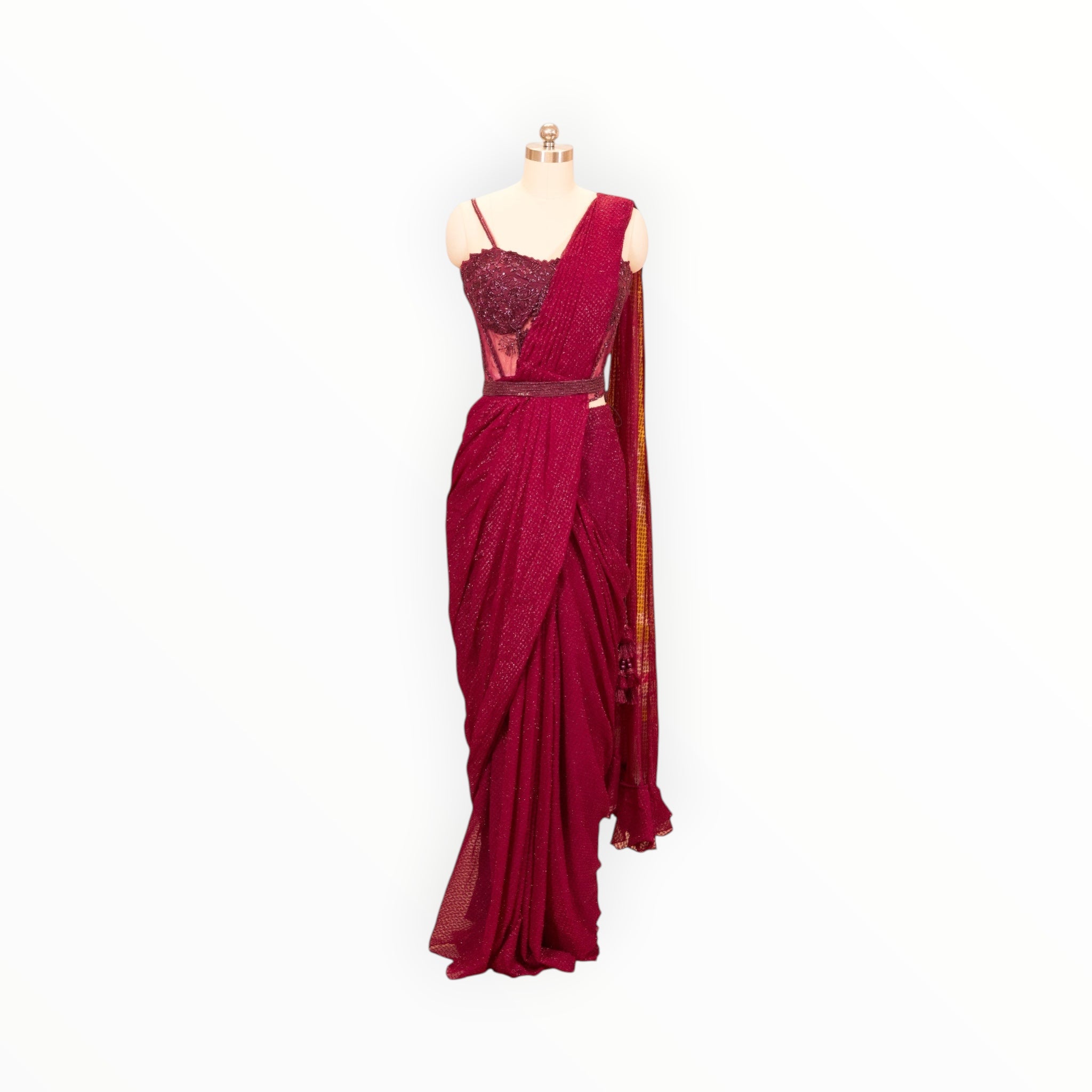Zari Designs maroon pre-draped saree with an embellished corset blouse and matching waist belt on a mannequin.