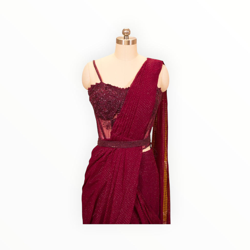 Zari Designs maroon drape saree featuring a heavily embellished corset-style bodice with intricate beadwork and sequins.