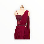 Zari Designs maroon drape saree featuring a heavily embellished corset-style bodice with intricate beadwork and sequins.