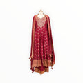 Zari Designs maroon Anarkali suit with intricate gold embroidery, V-neckline, and matching dupatta on a mannequin