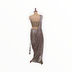 Zari Designs metallic silver ready-to-wear saree with a sleeveless embellished blouse and draped skirt on a mannequin