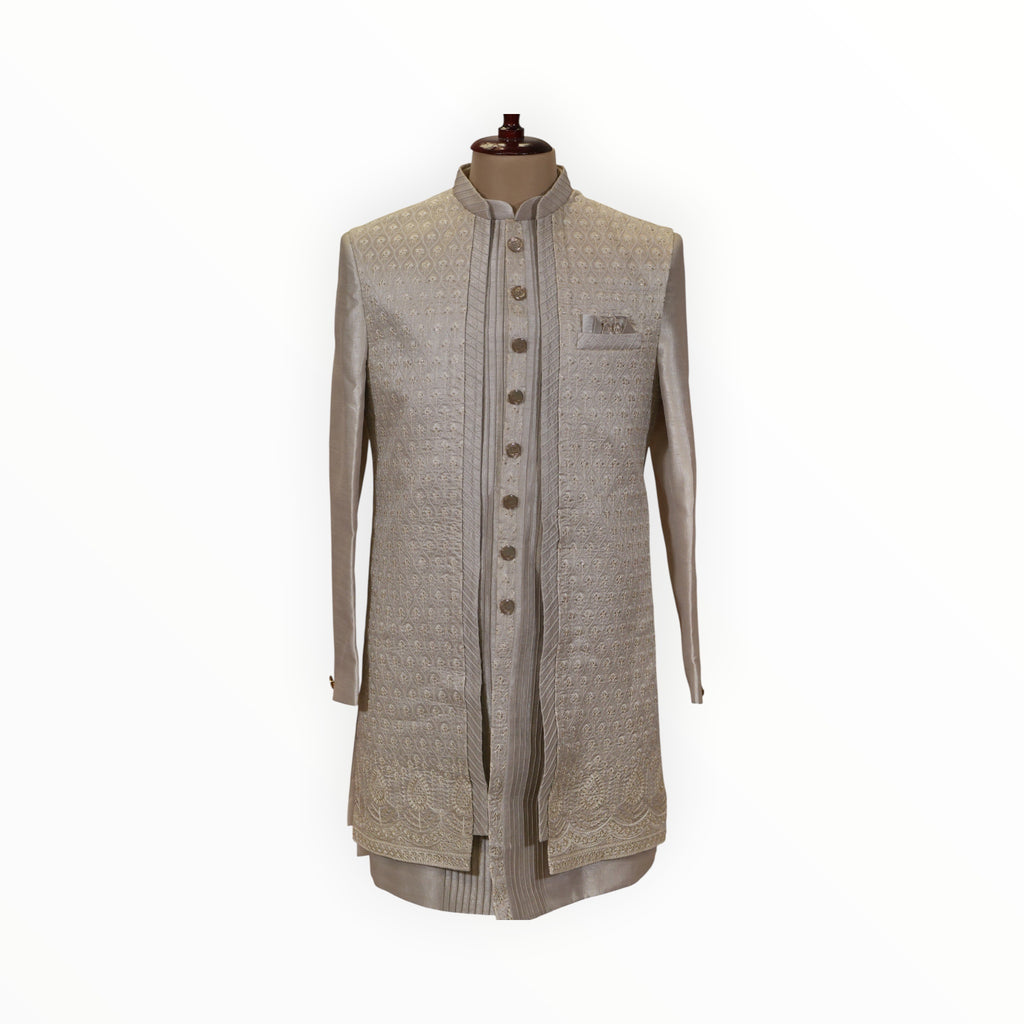 Zari Designs men's off-white Indo-Western sherwani with intricate embroidery, metallic buttons, and pocket square.