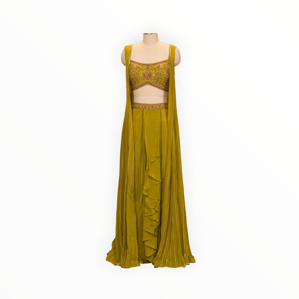 Zari Designs olive green drape saree with a sleeveless embroidered blouse and ruffled skirt detail on a mannequin