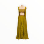 Zari Designs olive green drape saree with a sleeveless embroidered blouse and ruffled skirt detail on a mannequin