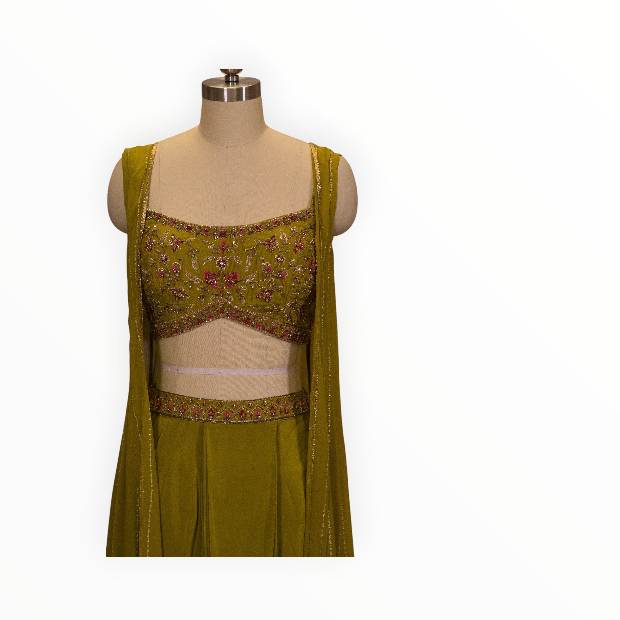 Zari Designs olive green drape saree featuring a sleeveless blouse with intricate floral embroidery and beadwork.