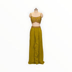 Zari Designs olive green drape saree with an embroidered sleeveless blouse and ruffled skirt on a mannequin