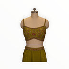 Zari Designs olive green sleeveless blouse with intricate floral embroidery, beadwork, and sequins on a mannequin.