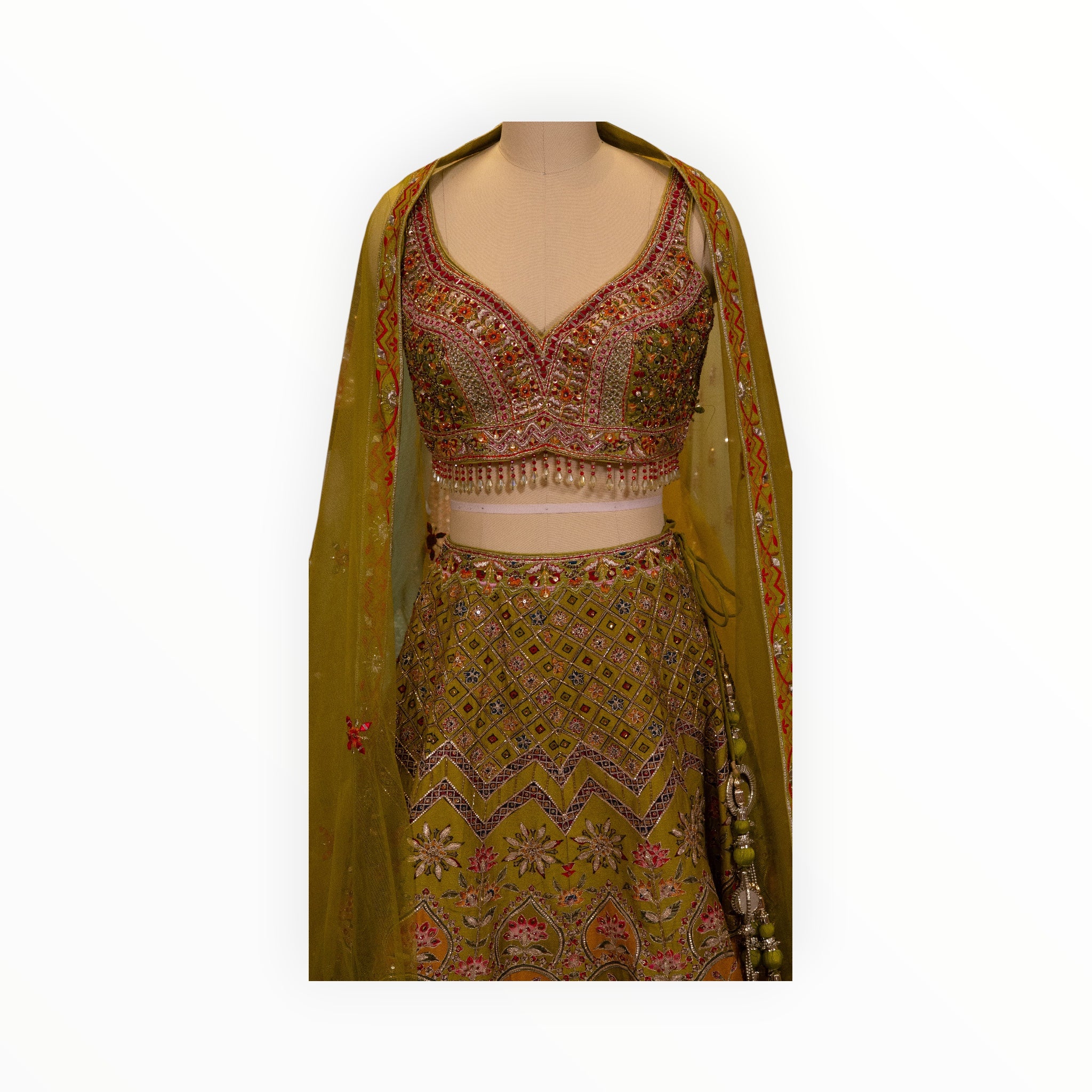 Zari Designs Carnival Lehnga in olive green with intricate floral embroidery, beadwork, and a matching sheer dupatta.