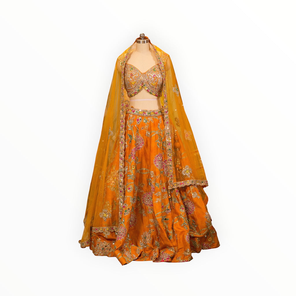 Zari Designs embellished orange lehenga choli set with intricate floral embroidery and matching sheer dupatta