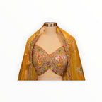 Zari Designs Carnival Lehnga featuring a vibrant orange blouse with intricate mirror work and colorful embroidery.