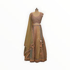 Zari Designs peach and pastel multi-colored lehenga choli with intricate mirror work, embroidery, and tassel details.